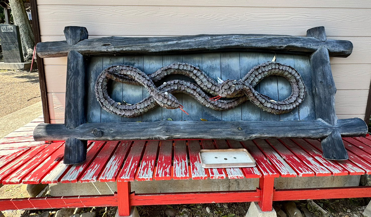 A carved wooden panel at the shrine